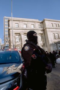 A Police Officer Standing by a Car